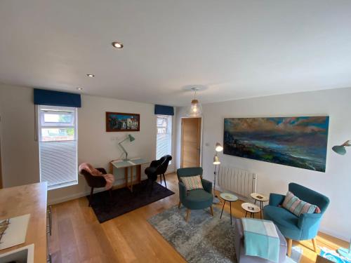 a living room filled with furniture and a painting on the wall at Self-contained, ground floor apartment with parking and patio in Walmer