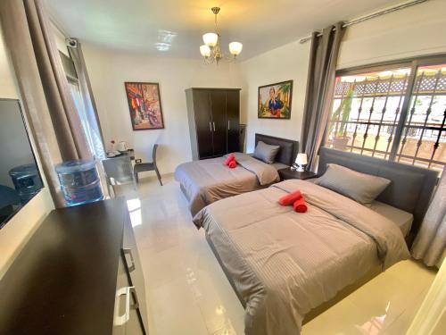 a bedroom with two beds with red bows on them at Villa Mira GuestHouse 2 - Downtown Central Amman - AL DIYRIH in Amman