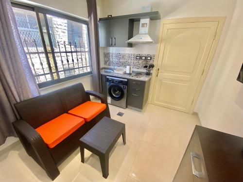 an orange bench in a kitchen with a window at Villa Mira GuestHouse 2 - Downtown Central Amman - AL DIYRIH in Amman