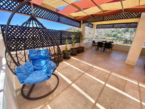 a room with a chair on a balcony at Villa Mira GuestHouse 2 - Downtown Central Amman - AL DIYRIH in Amman
