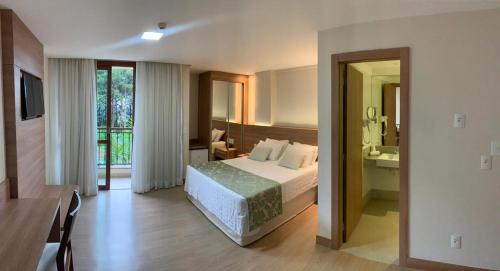 ein Hotelzimmer mit einem Bett und einem Badezimmer in der Unterkunft Quarto inteiro, Condomínio Vista Azul, Pedra Azul in Domingos Martins