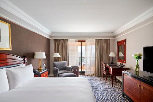 a hotel room with a bed and a desk at InterContinental Cairo Semiramis by IHG in Cairo