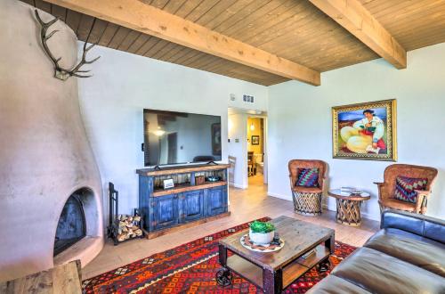 a living room with a couch and a fireplace at Traditional-Style Adobe Casita - Walk to Dtwn in Santa Fe