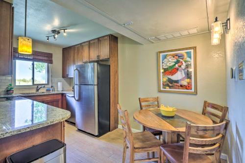 a kitchen with a table and a stainless steel refrigerator at Traditional-Style Adobe Casita - Walk to Dtwn in Santa Fe