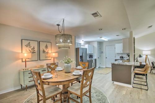 a dining room and kitchen with a table and chairs at Cozy-Modern Pensacola Home Large Yard, Grill in Pensacola