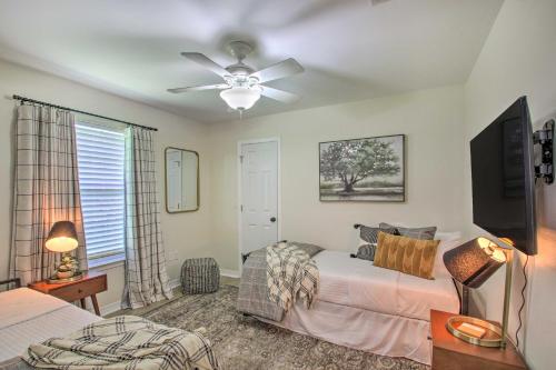 a bedroom with a bed and a ceiling fan at Cozy-Modern Pensacola Home Large Yard, Grill in Pensacola