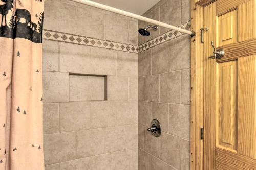 a bathroom with a shower with a shower curtain at Gated Community with Perks Cozy Sparta Cabin! in Whitehead