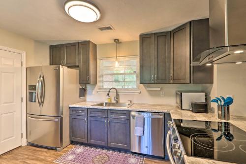 a kitchen with wooden cabinets and a stainless steel refrigerator at about 8 Mi to FSU Bright Tallahassee Retreat! in Tallahassee