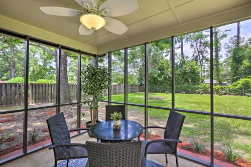 a screened porch with a table and chairs and large windows at about 8 Mi to FSU Bright Tallahassee Retreat! in Tallahassee