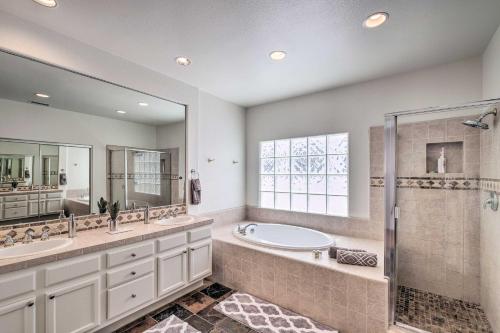 a bathroom with a tub and a shower and a sink at Oceanside Home with Rooftop Patio - Steps to Beach! in Oceanside