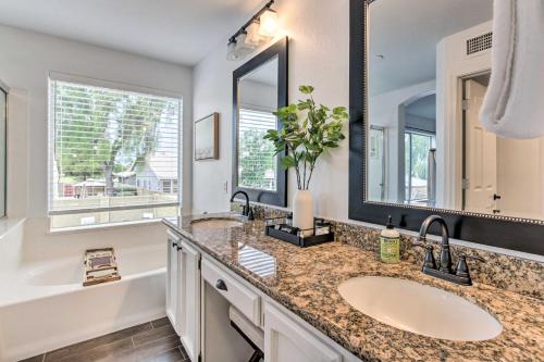a bathroom with two sinks and a large mirror at Beautiful Chandler Escape with Putting Green and Pool! in Chandler