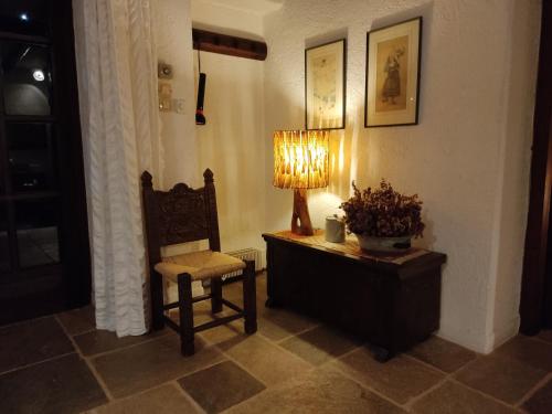 a living room with a chair and a lamp at Lito's dream villa by the sea! in Amaliápoli