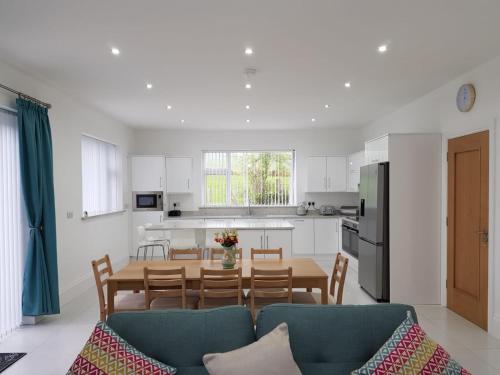 a kitchen and dining room with a table and chairs at Annie's House with Thermal Health Spa in Moville