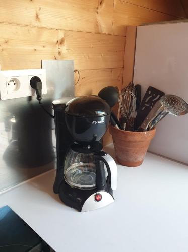 a black and white coffee maker sitting on a counter at WhispeRive Lodge - le vert aux bords de rive in Le Bourg-dʼOisans