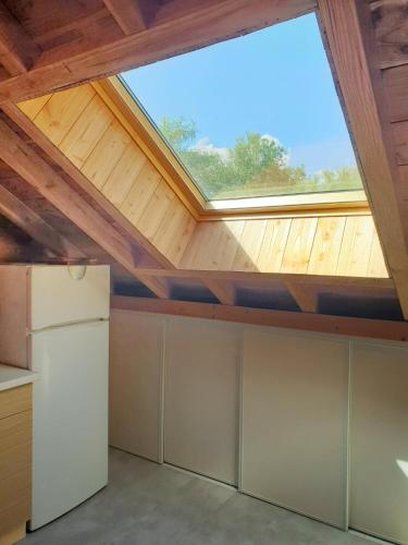 a skylight in a kitchen with a ceiling at WhispeRive Lodge - le vert aux bords de rive in Le Bourg-dʼOisans