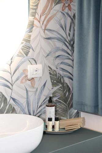 a bathroom with a sink and a shower curtain at C House Rooms Lake in Peschiera del Garda