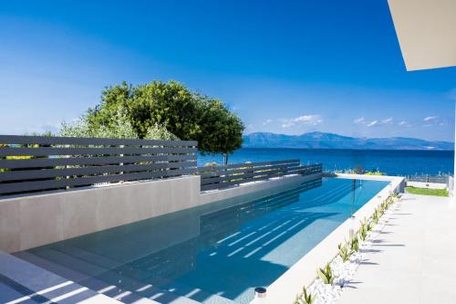 a swimming pool with a view of the water at Theros Suites in Dhiminión