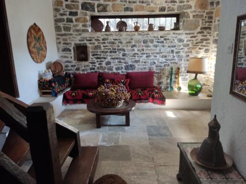 a living room with a couch and a table at Lito's dream villa by the sea! in Amaliápoli