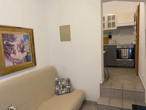 a living room with a couch and a painting on the wall at Apartments Lav in Umag