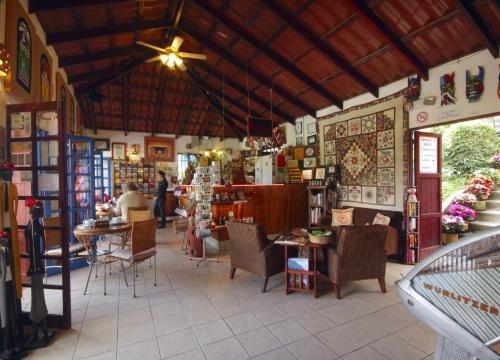 a store with chairs and tables in a building at Orosi Lodge in Orosí