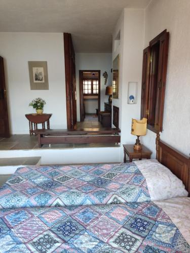 a bedroom with a bed with a quilt on it at Lito's dream villa by the sea! in Amaliápoli