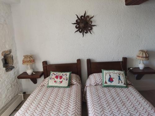 two twin beds with pillows on them in a bedroom at Lito's dream villa by the sea! in Amaliápoli