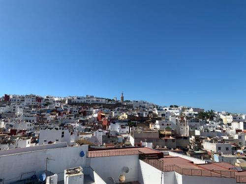 a view of a city with white buildings at Riad Tingis in Tangier