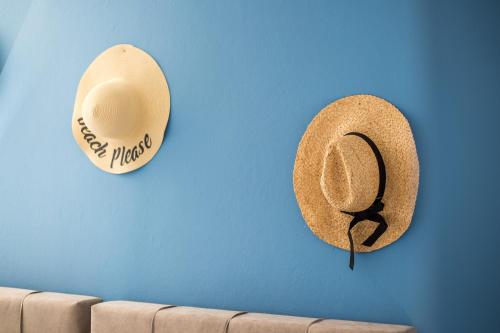 a hat hanging on a blue wall next to a couch at Villa Euphrosyne in Líndos