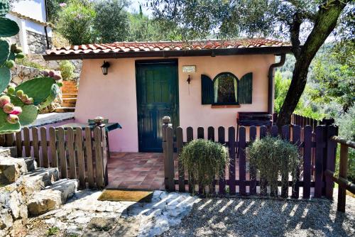 a small house with a fence in front of it at La Maison Galu' in Itri