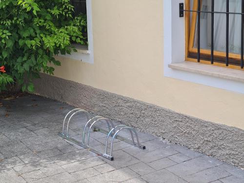 a metal object sitting on a sidewalk next to a building at Apartma Dora Bovec in Bovec