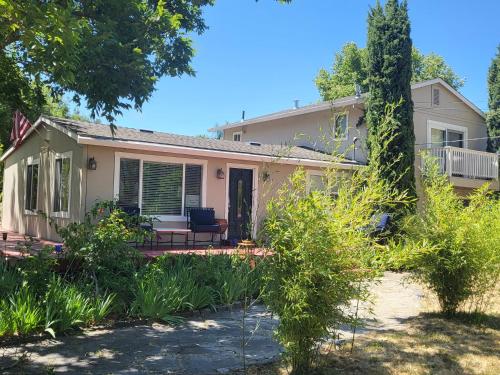 a white house with a porch and a yard at Sonoma Wine Country Bungalow in Sonoma