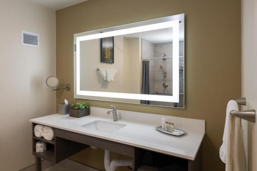 a bathroom with a sink and a large mirror at Apache Gold Resort Hotel & Casino in Globe