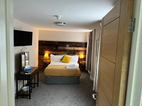 ein Hotelzimmer mit einem Bett und einem Schreibtisch in der Unterkunft The Brookmill in London