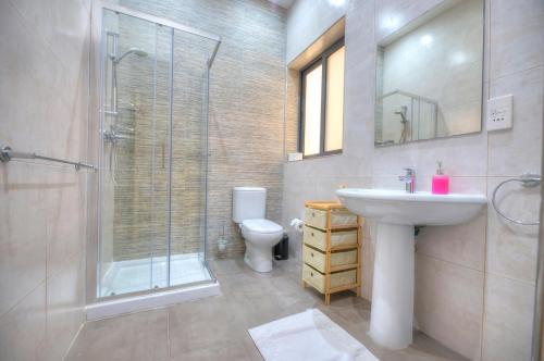 a bathroom with a sink and a shower and a toilet at Spacious and beautifully furnished 3 bedrooms/3bathrooms apartment with 2 balconies WVID1-1 in Il-Gżira