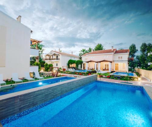 a swimming pool in the backyard of a house at Corinthian Village in Vrachati