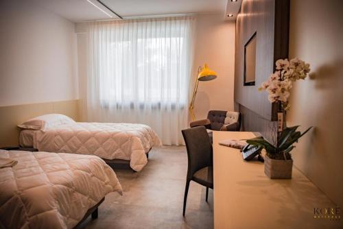 Ένα ή περισσότερα κρεβάτια σε δωμάτιο στο Korè Hotel