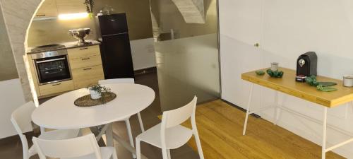 a small kitchen with a white table and chairs at BorgoAntico34 - Luxury Room in Molfetta