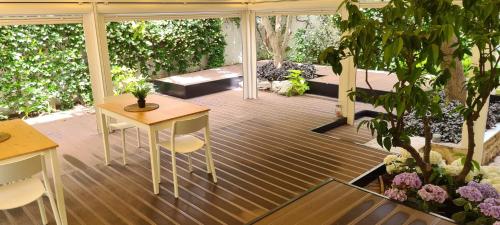 a screened porch with a table and chairs on it at BorgoAntico34 - Luxury Room in Molfetta