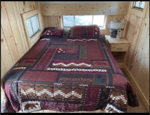 a bedroom with two beds in a log cabin at Glamping property in Panorama Heights