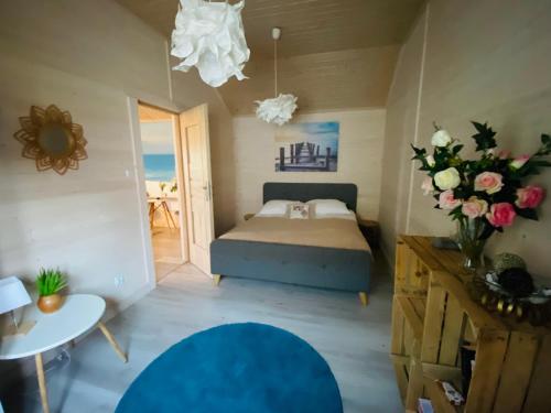 a bedroom with a bed and a vase of flowers at Siedlisko Wytowno in Ustka