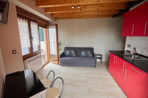 a kitchen and a living room with a couch at La besñada in Cangas de Onís