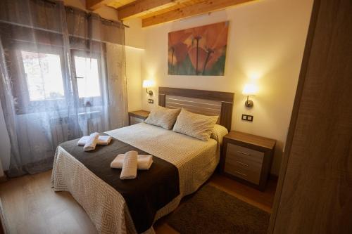a bedroom with a bed with two towels on it at La besñada in Cangas de Onís