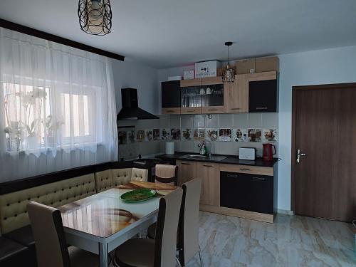a kitchen with a table and a dining room at Vila Nikol in Năvodari