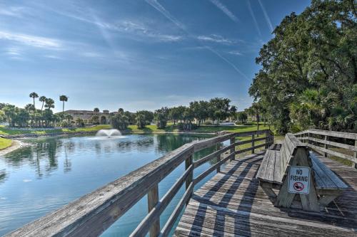 a wooden bridge over a river with a no swimming sign at Waterfront Palm Coast Condo with Boat Dock and Pool! in Palm Coast