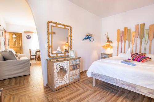 a bedroom with a bed and a mirror on the wall at Gorgona Blue Apartments in Karpathos Town