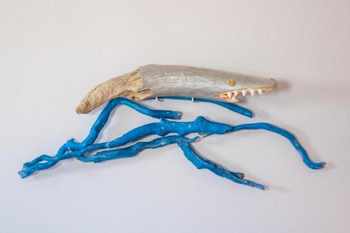 a skeleton of a dinosaur on a white wall at Gorgona Blue Apartments in Karpathos Town
