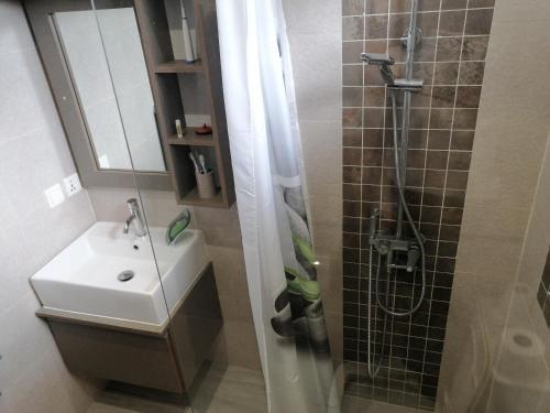 a bathroom with a sink and a shower at VH Newave holiday in Flic-en-Flac
