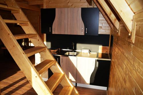 a kitchen with a staircase leading up to a kitchen with a sink at Peace of mind in Visoko