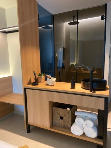 a bathroom with a counter with towels and a mirror at Hotel Farsund in Sanxenxo