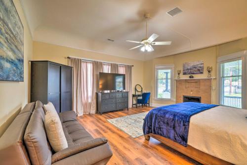 a bedroom with a bed and a couch and a tv at Cozy Carpinteria Apartment Walkable Location in Carpinteria